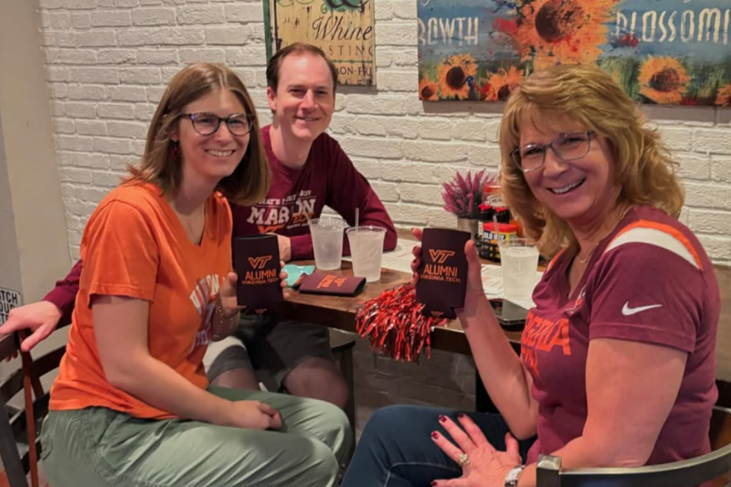 Baltimore Hokies pose for a picture during a happy hour event