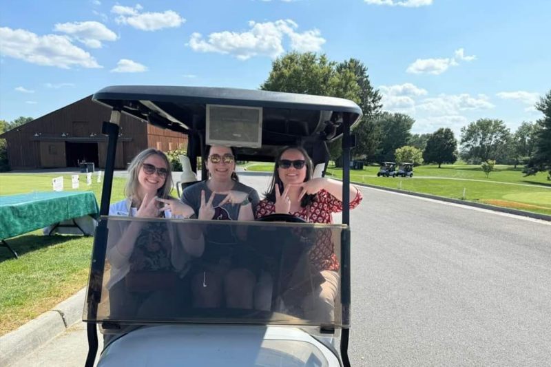Shenandoah Hokies in a golf card during their annual tournament