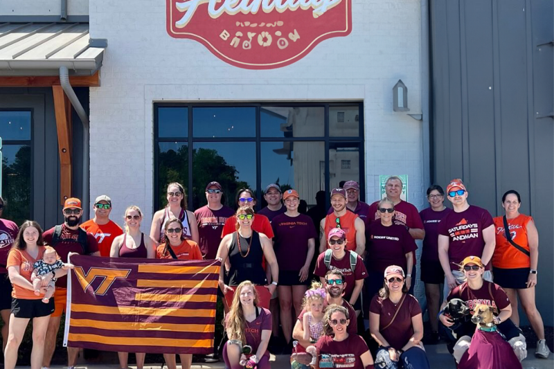 Triangle alums pose outside a building
