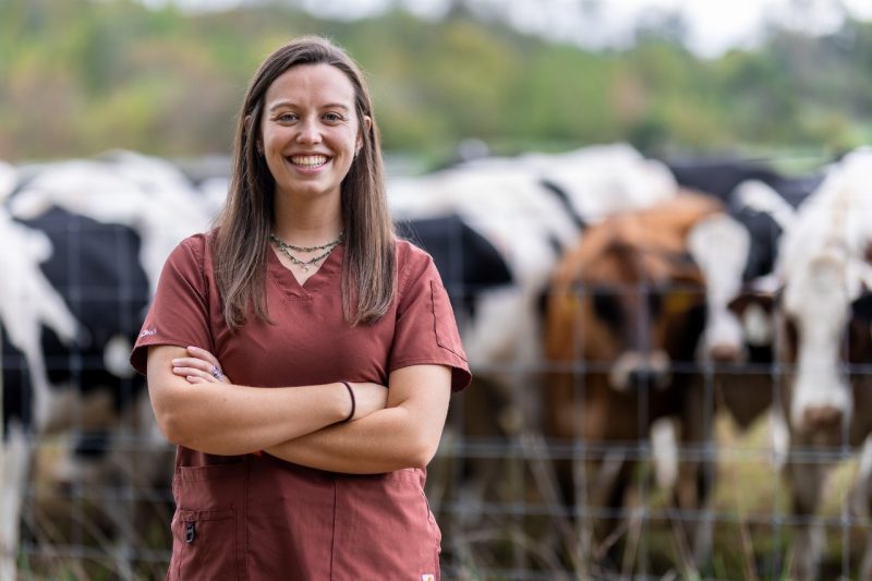 Kelly Gillespie posing in front of a cow field